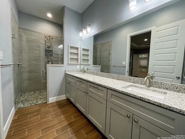 a bathroom with a double vanity sink and a mirror