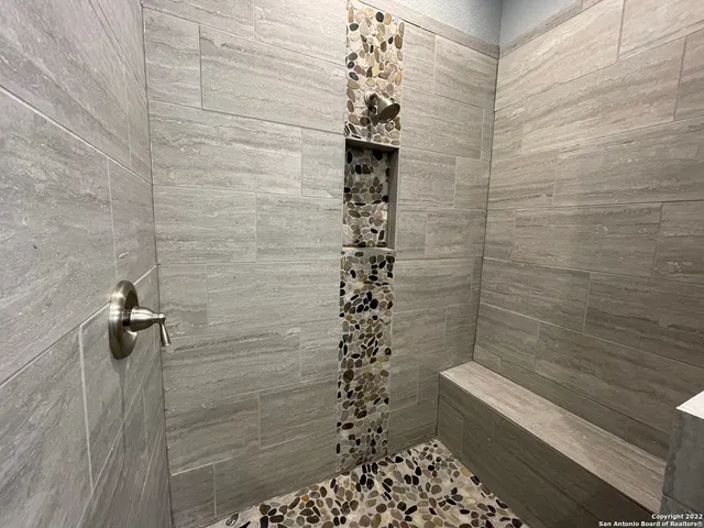 a bathroom with a shower and a sink