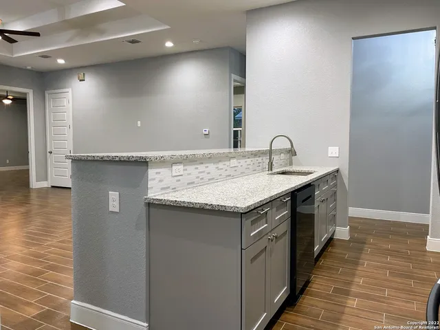 a kitchen with a sink and cabinets