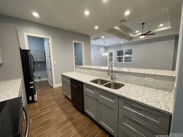 a kitchen with sink and mirror