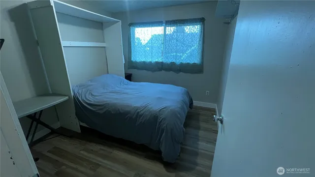 a bed sitting in a bedroom next to a window