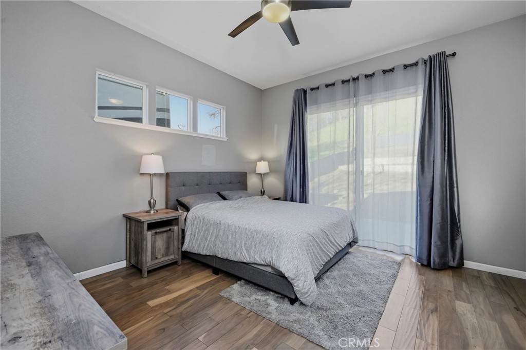 18216 Hidden Valley Road Hidden Valley Lake, CA 95467 - Photo 11 of 26 a bedroom with a bed and wooden floor