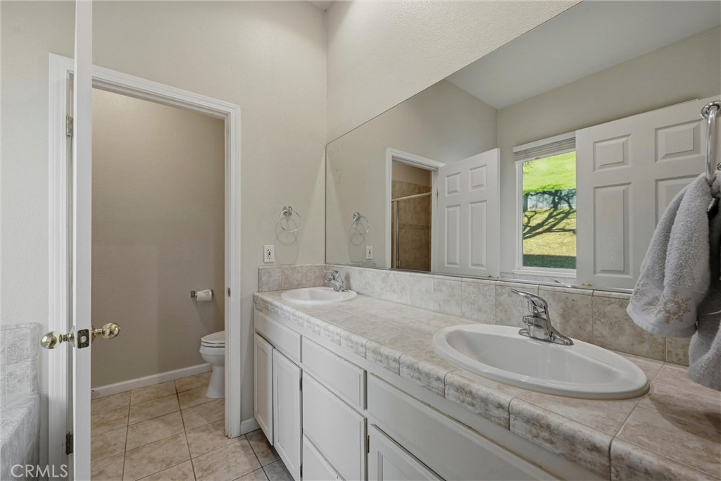 18216 Hidden Valley Road Hidden Valley Lake, CA 95467 - Photo 13 of 26 a bathroom with a sink and a mirror
