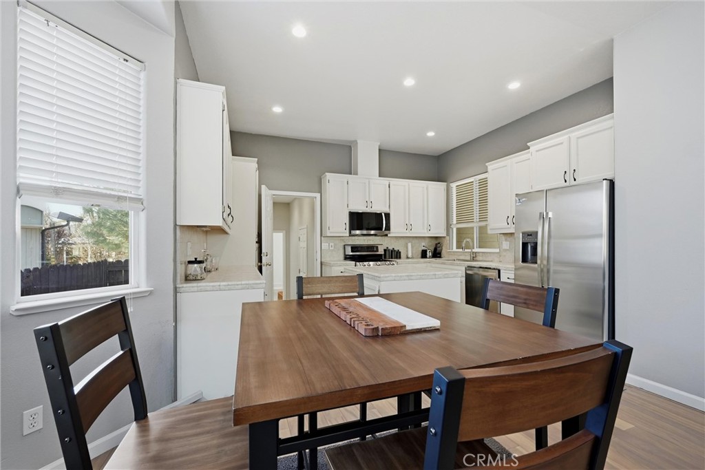 18216 Hidden Valley Road Hidden Valley Lake, CA 95467 - Photo 9 of 26 a kitchen with stainless steel appliances granite countertop a dining table chairs refrigerator and microwave