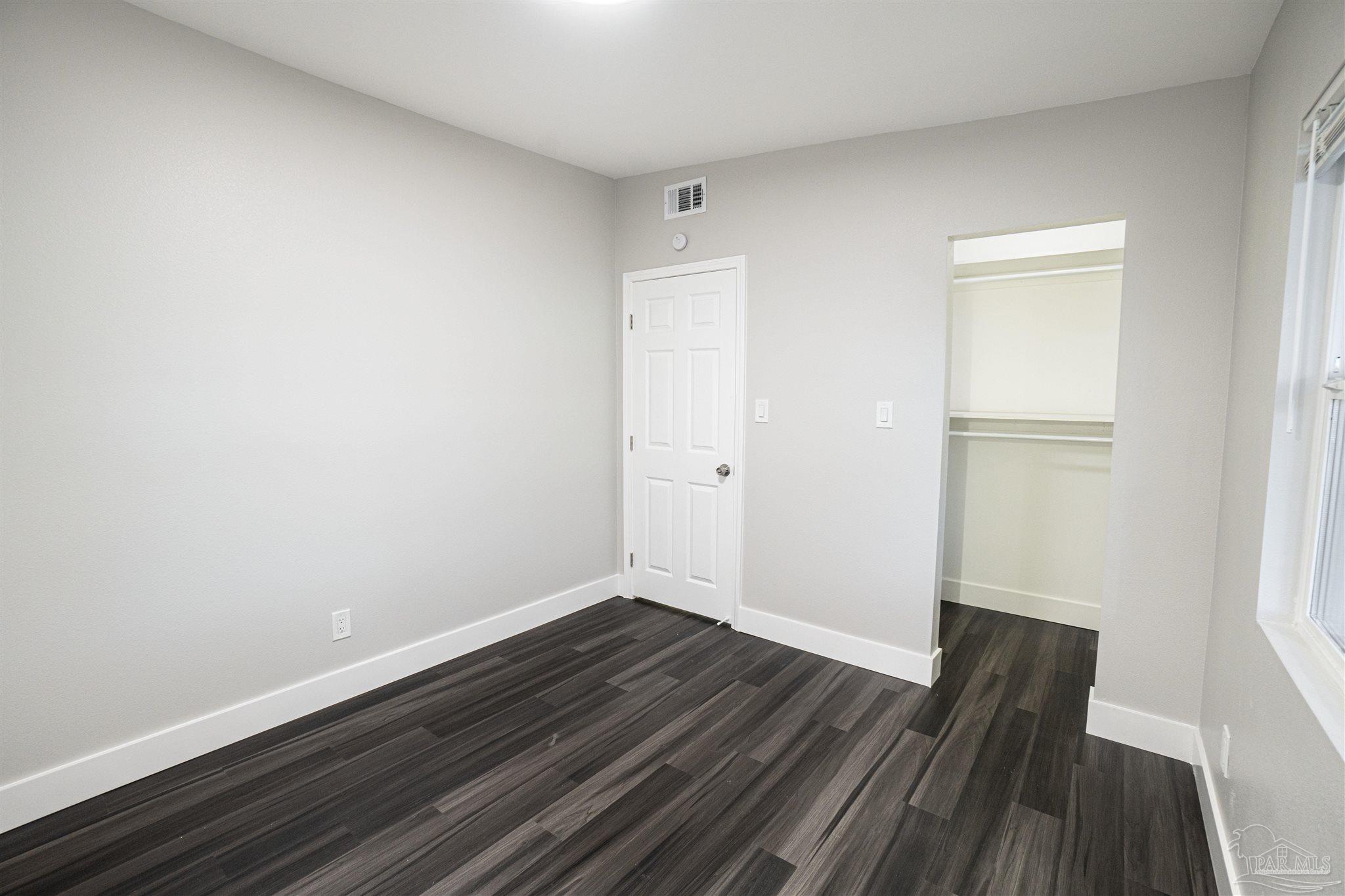 426 Forrest Street Cantonment, FL 32533 - Photo 11 of 25 an empty room with wooden floor