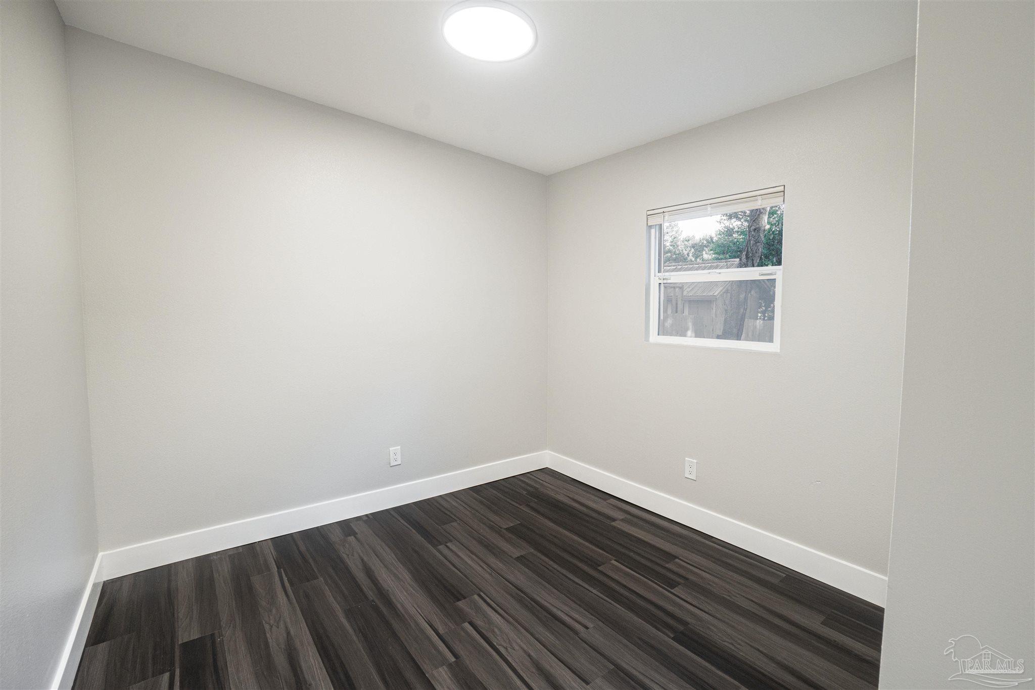 426 Forrest Street Cantonment, FL 32533 - Photo 13 of 25 a view of an empty room and wooden floor