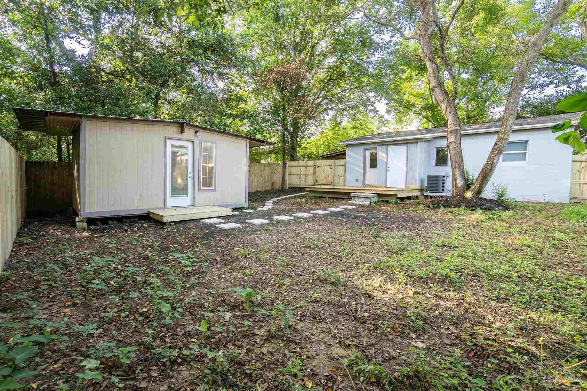 426 Forrest Street Cantonment, FL 32533 - Photo 19 of 25 a view of a backyard with large tree