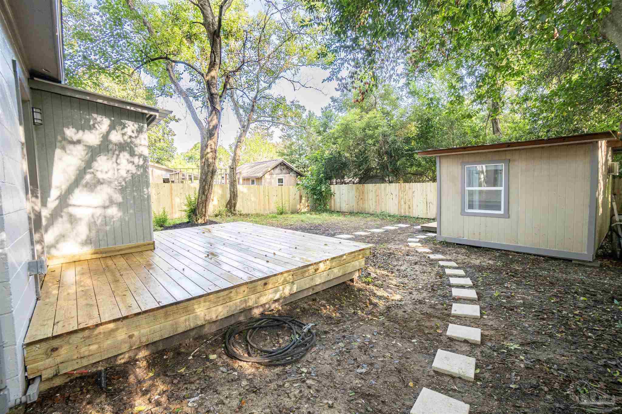 426 Forrest Street Cantonment, FL 32533 - Photo 22 of 25 a view of a backyard with a tree