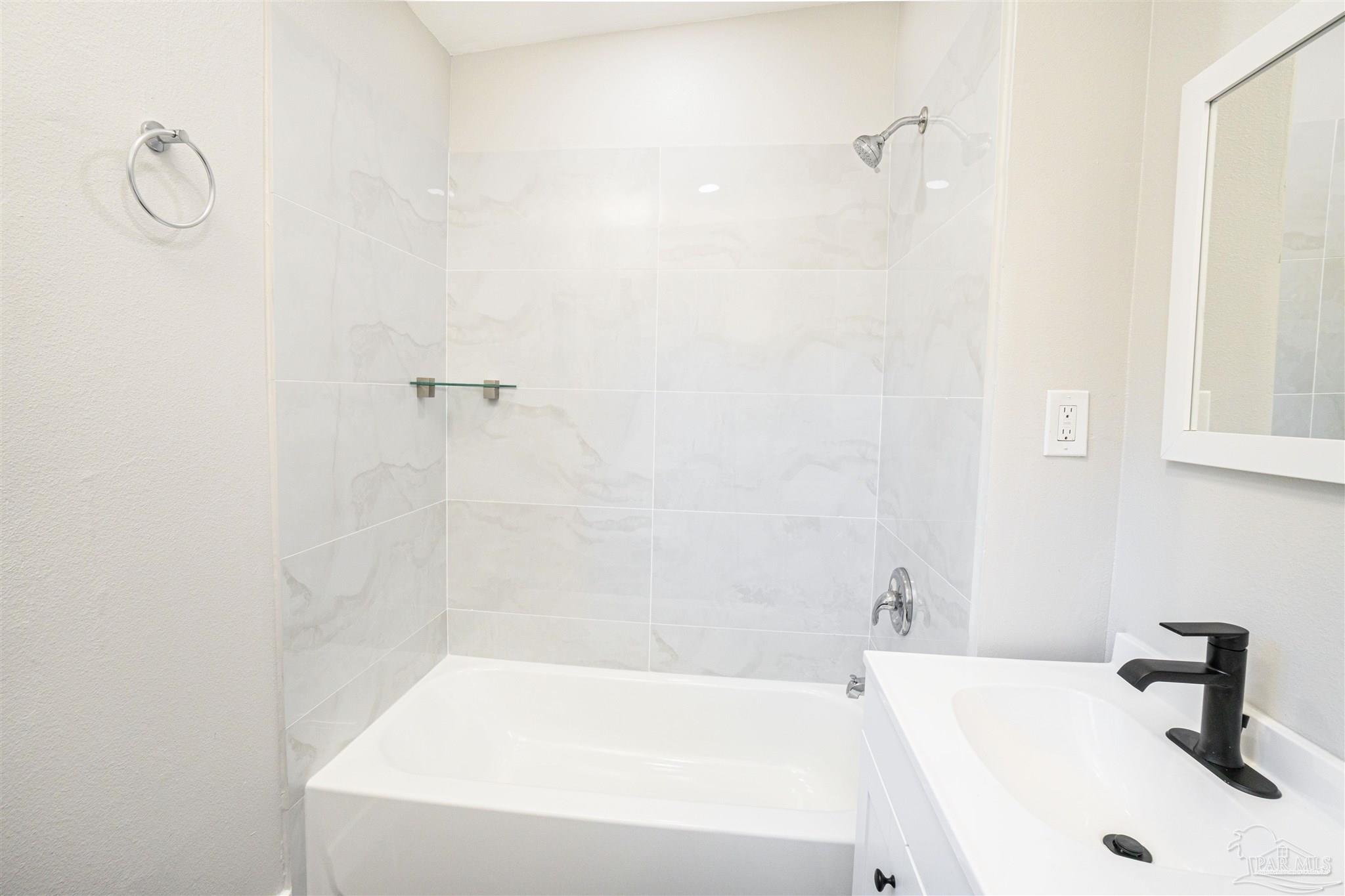 426 Forrest Street Cantonment, FL 32533 - Photo 8 of 25 a white bath tub sitting next to a white sink