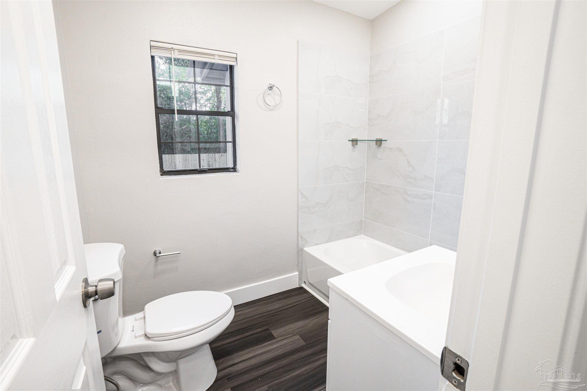 426 Forrest Street Cantonment, FL 32533 - Photo 9 of 25 a bathroom with a sink a toilet and shower