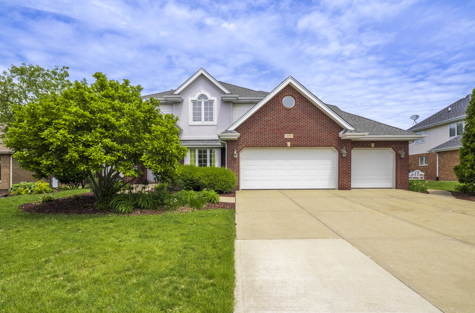a front view of a house with a yard and garage