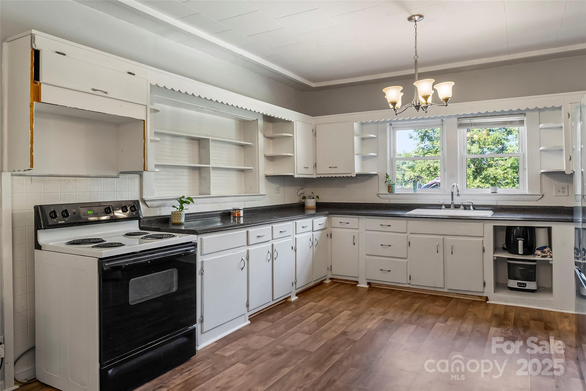 205 Abington Road Northwest Lenoir, NC 28645 - Photo 7 of 19 a kitchen with stainless steel appliances granite countertop a stove and white cabinets