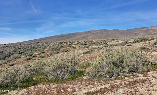 a view of a large mountain with mountains in the background