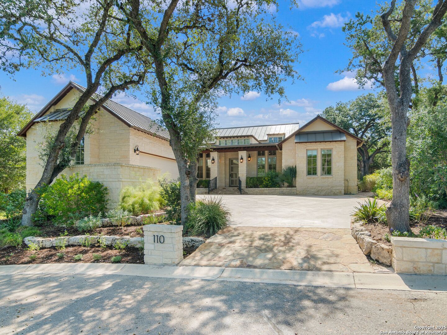 a view of a house with a tree in front