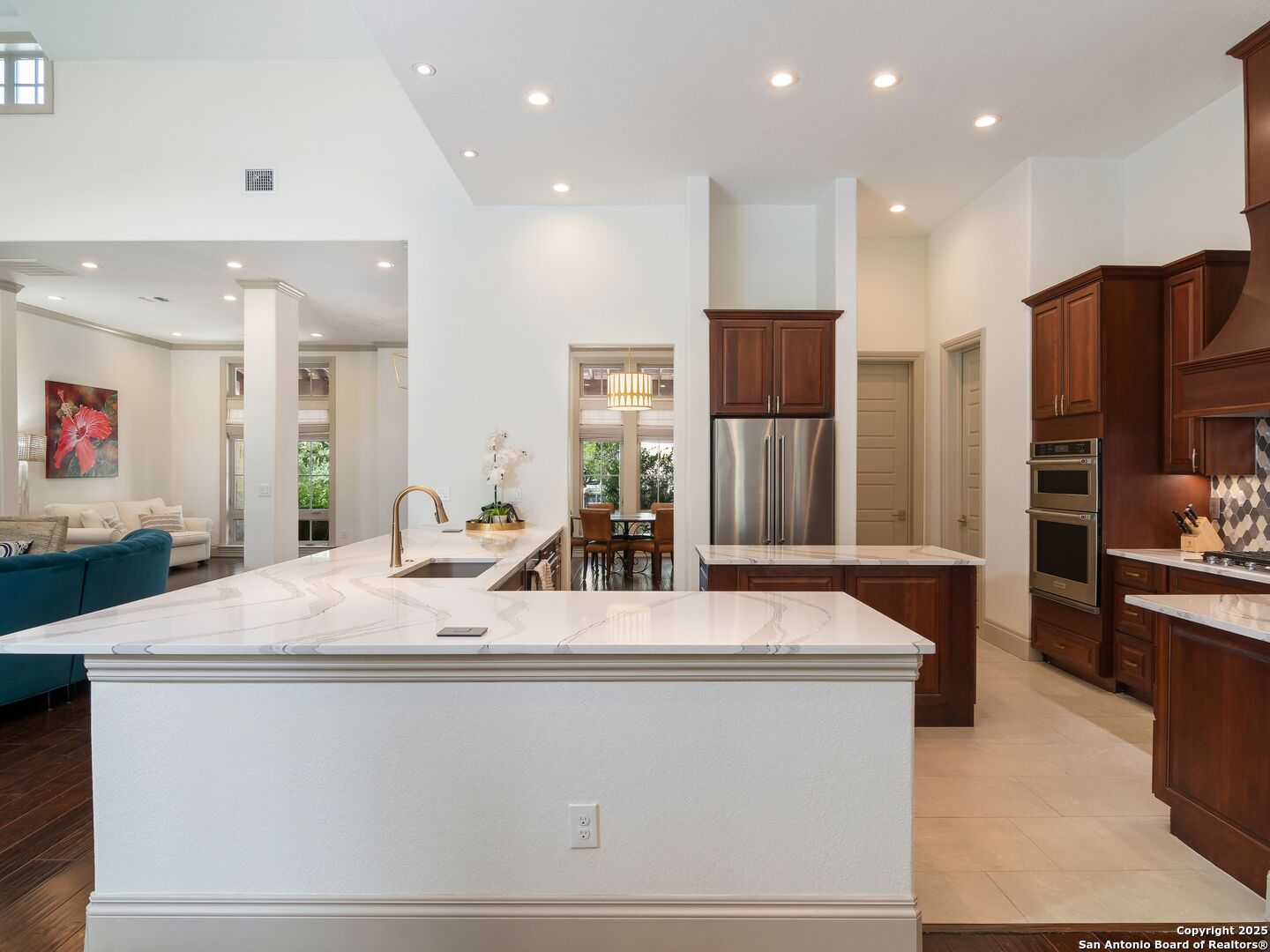 110 Manorbrook San Antonio, TX 78230 - Photo 14 of 40 a large kitchen with stainless steel appliances kitchen island a large counter top and a stove top oven
