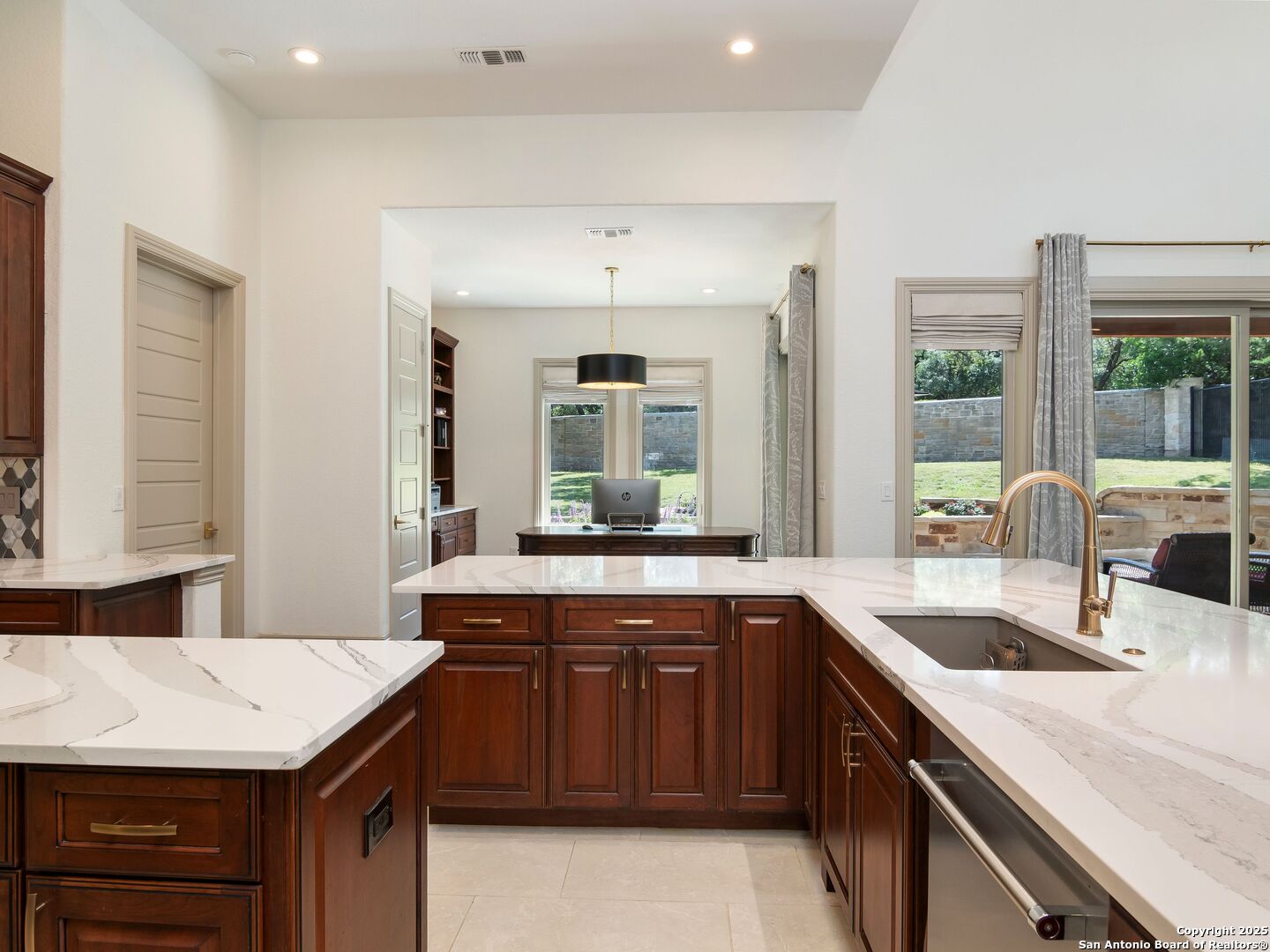 110 Manorbrook San Antonio, TX 78230 - Photo 17 of 40 a kitchen with a sink and a wooden cabinets