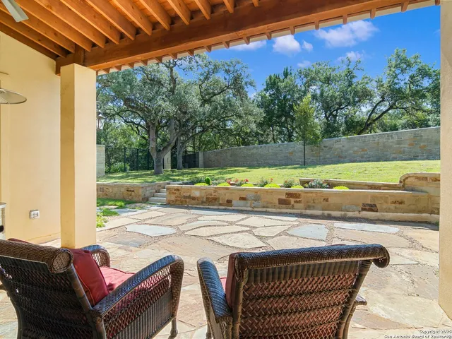 a view of a patio with a table and chairs