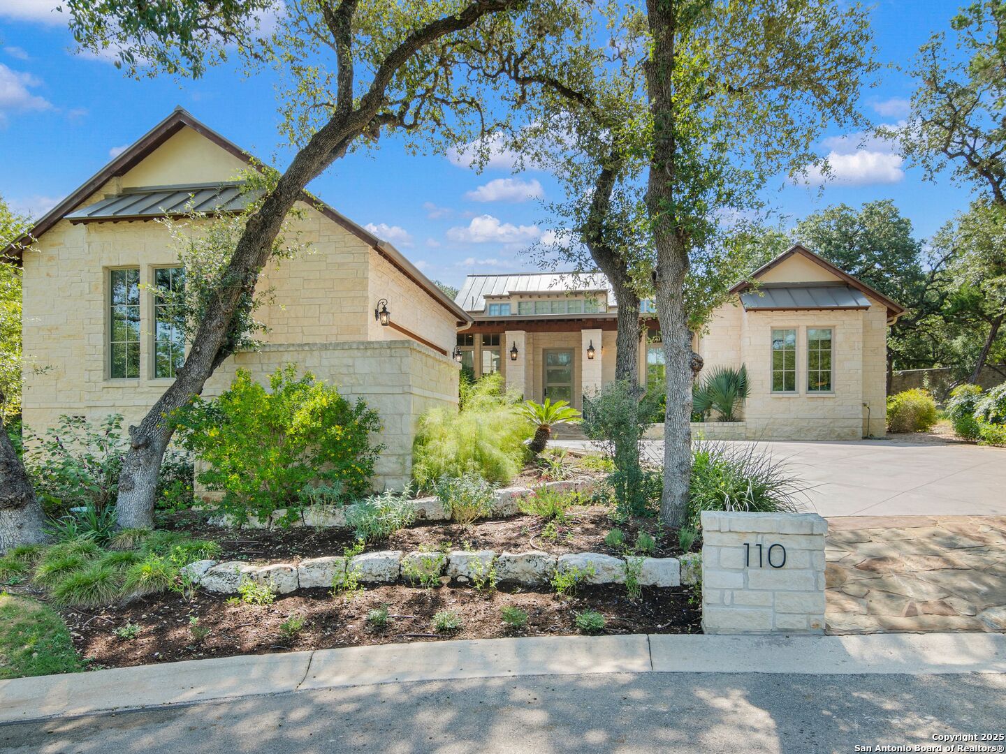 110 Manorbrook San Antonio, TX 78230 - Photo 38 of 40 a view of a white house with a yard and potted plants