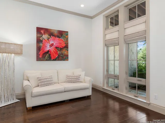 a living room with furniture and a painting on the wall