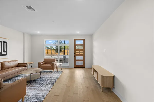 a living room with furniture and a large window