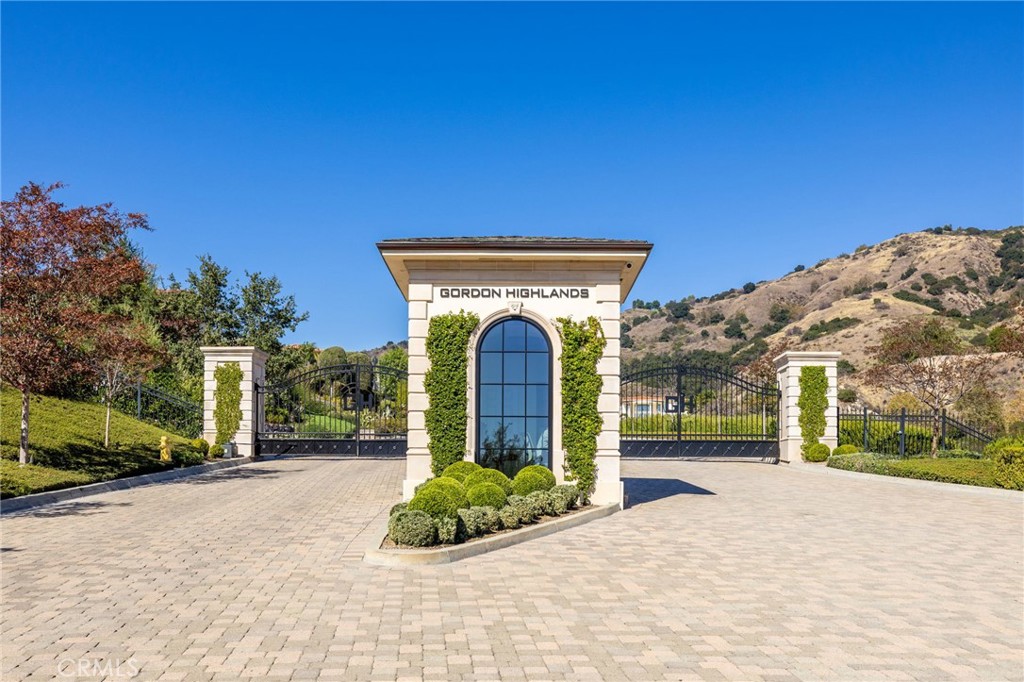 657 Gordon Highlands Road Glendora, CA 91741 - Photo 1 of 31 a view of a garden with a bench in front of it