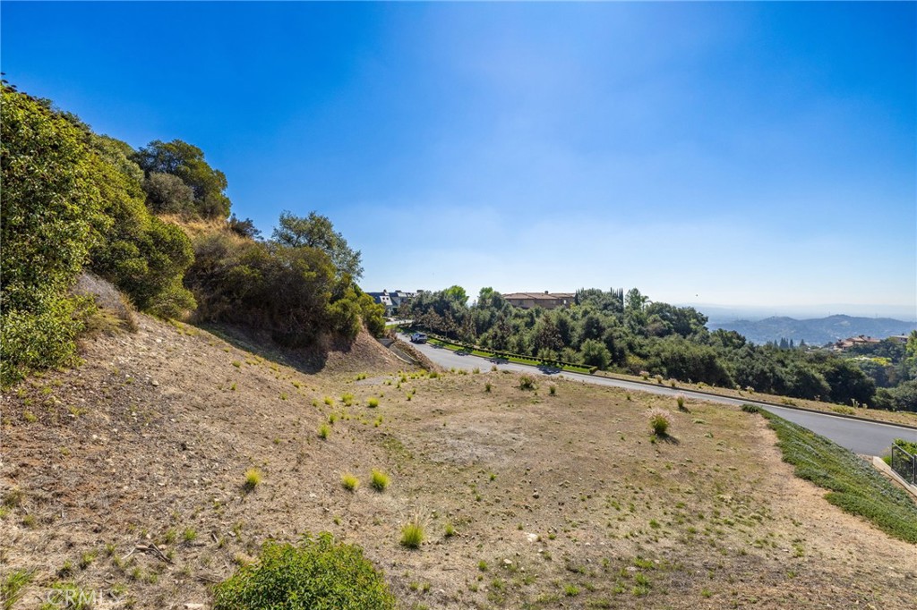 657 Gordon Highlands Road Glendora, CA 91741 - Photo 8 of 31 a view of a dry yard with mountains in the background