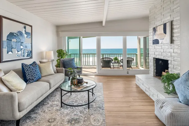 a living room with furniture large window and a fireplace