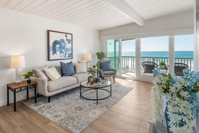 a living room with furniture and a floor to ceiling window