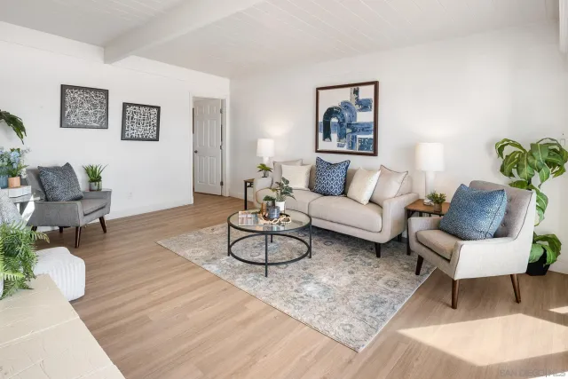 a living room with furniture and white walls