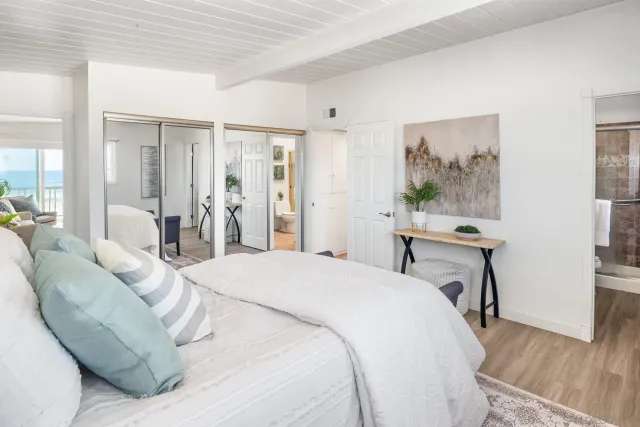 a spacious bedroom with a bed and a desk