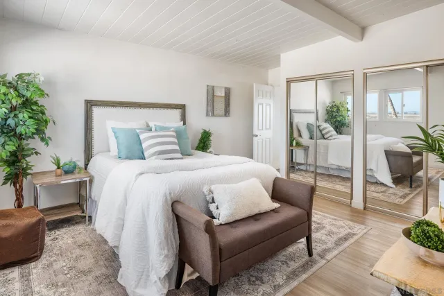 a bedroom with a large bed and a couch