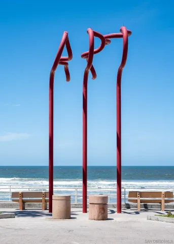 a street sign on a wall next to a road