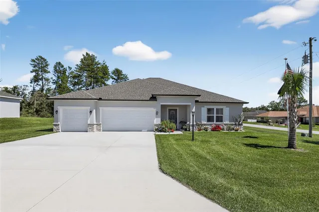 a front view of house with a garden and patio