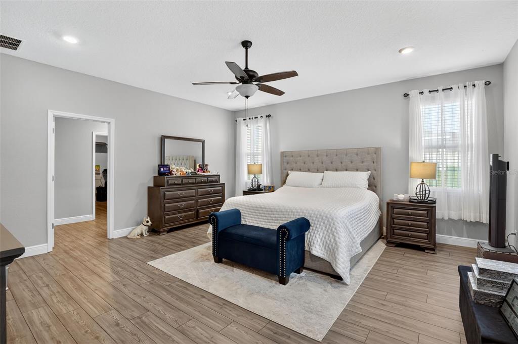 9839 Southwest 40th Terrace Ocala, FL 34476 - Photo 13 of 16 a bedroom with a bed and wooden floor