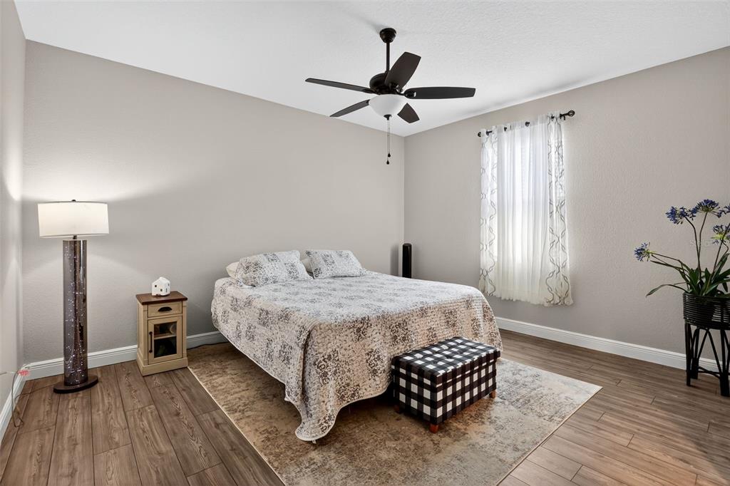 9839 Southwest 40th Terrace Ocala, FL 34476 - Photo 14 of 16 a bedroom with a bed chandelier and a window