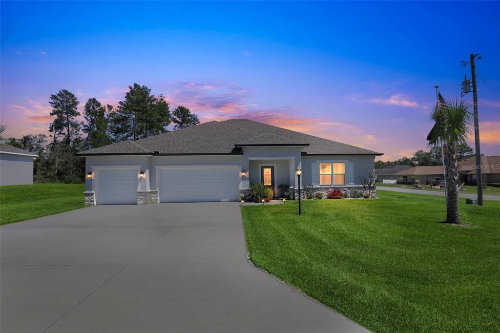 9839 Southwest 40th Terrace Ocala, FL 34476 - Photo 3 of 16 a front view of a house with a yard and garage