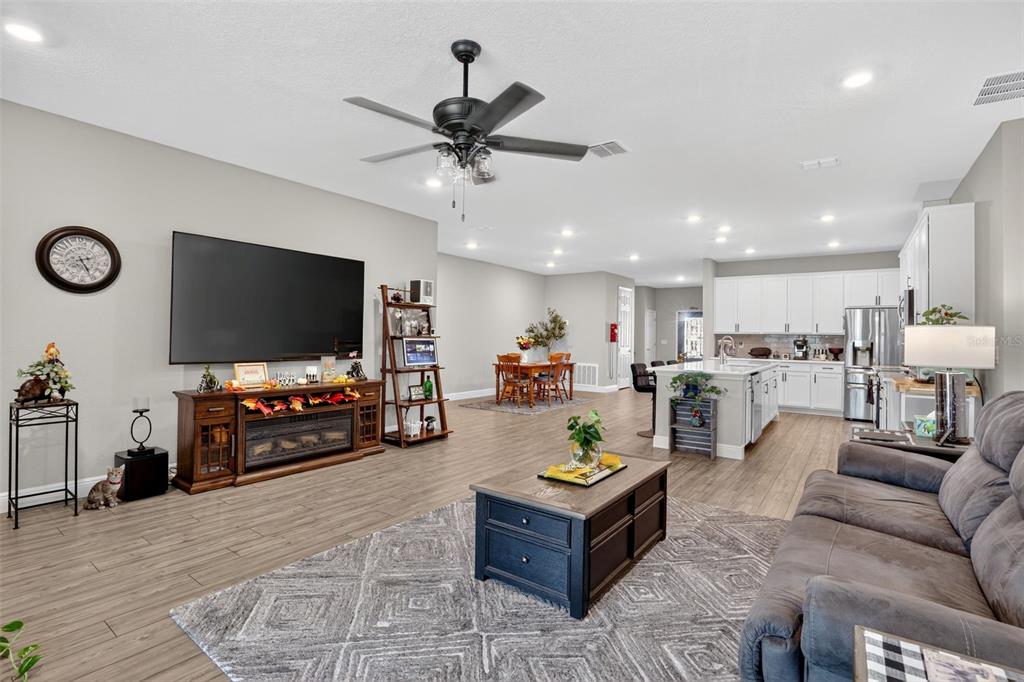9839 Southwest 40th Terrace Ocala, FL 34476 - Photo 5 of 16 a living room with furniture and a flat screen tv