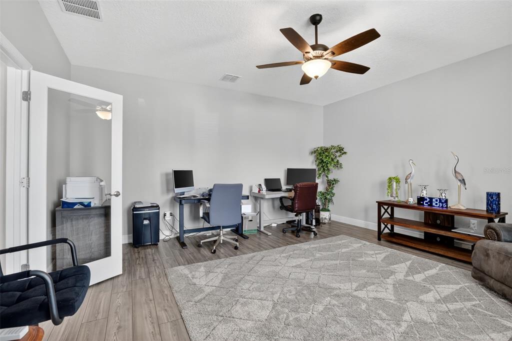 9839 Southwest 40th Terrace Ocala, FL 34476 - Photo 7 of 16 a work room with furniture and wooden floor