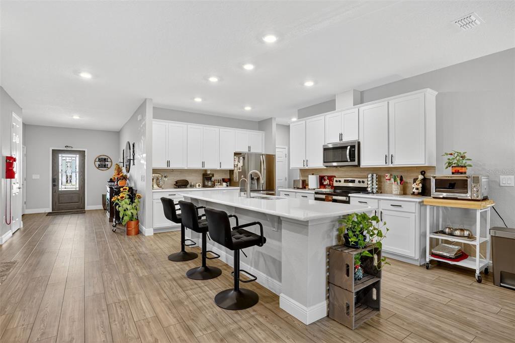 9839 Southwest 40th Terrace Ocala, FL 34476 - Photo 8 of 16 a kitchen with a sink white cabinets and appliances