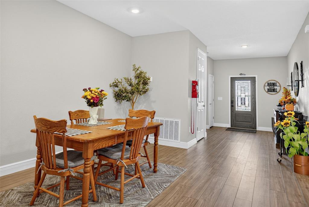 9839 Southwest 40th Terrace Ocala, FL 34476 - Photo 9 of 16 a view of a dining room with furniture and wooden floor