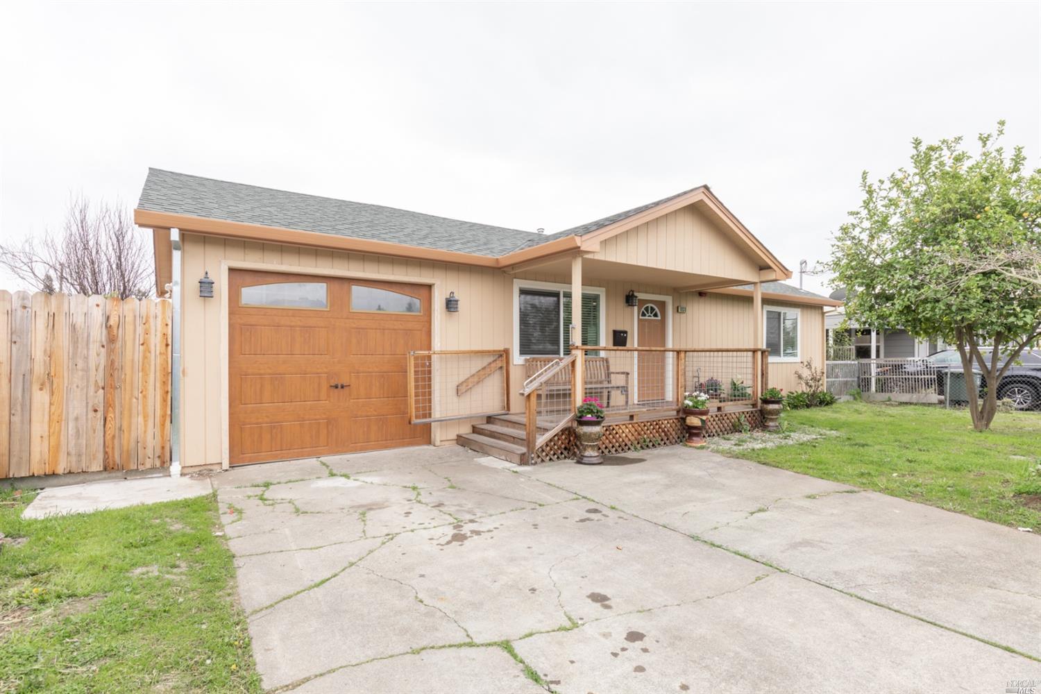 a backyard of a house with table and chairs