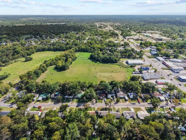 an aerial view of a houses with a yard