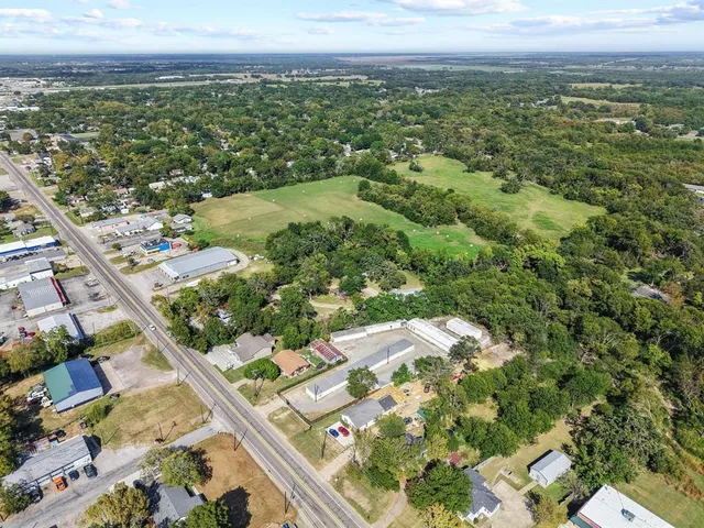an aerial view of residential houses with outdoor space