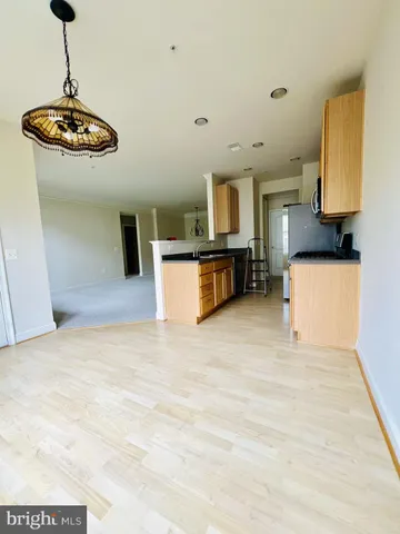 a view of a kitchen with a sink stainless steel appliances and cabinets