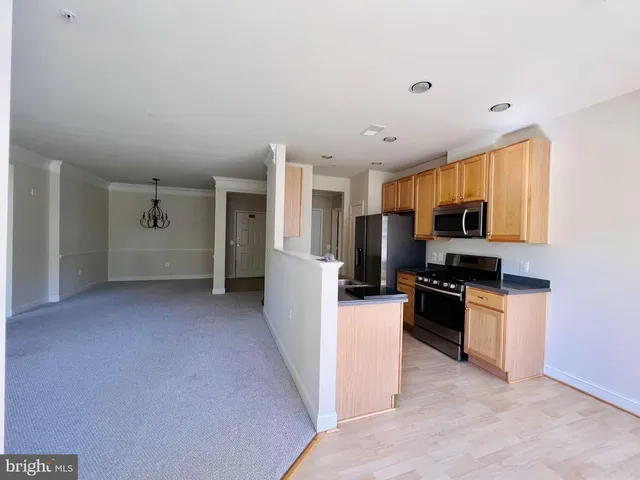 a kitchen with refrigerator and microwave