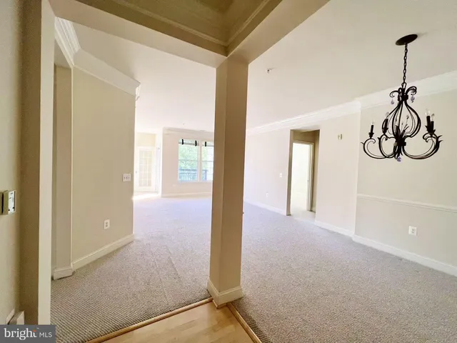 a view of hallway with chandelier