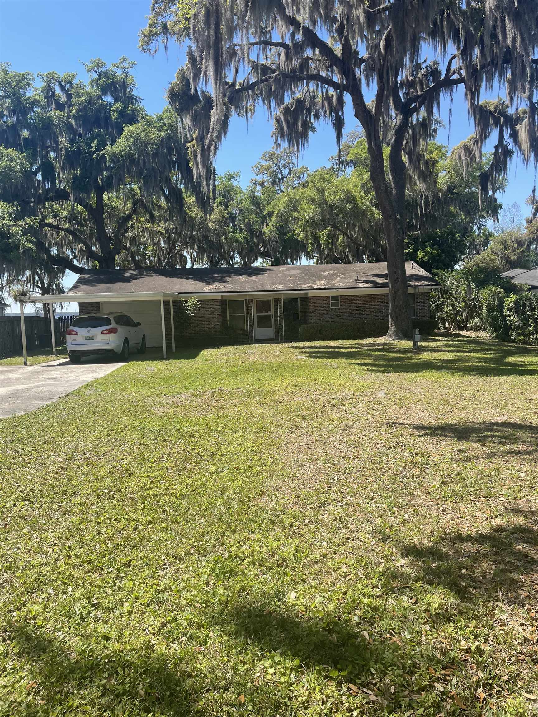 6373 Jack Wright Island Road St. Augustine, FL 32092 - Photo 2 of 4 Single story home with a front lawn, a carport, concrete driveway, and brick siding