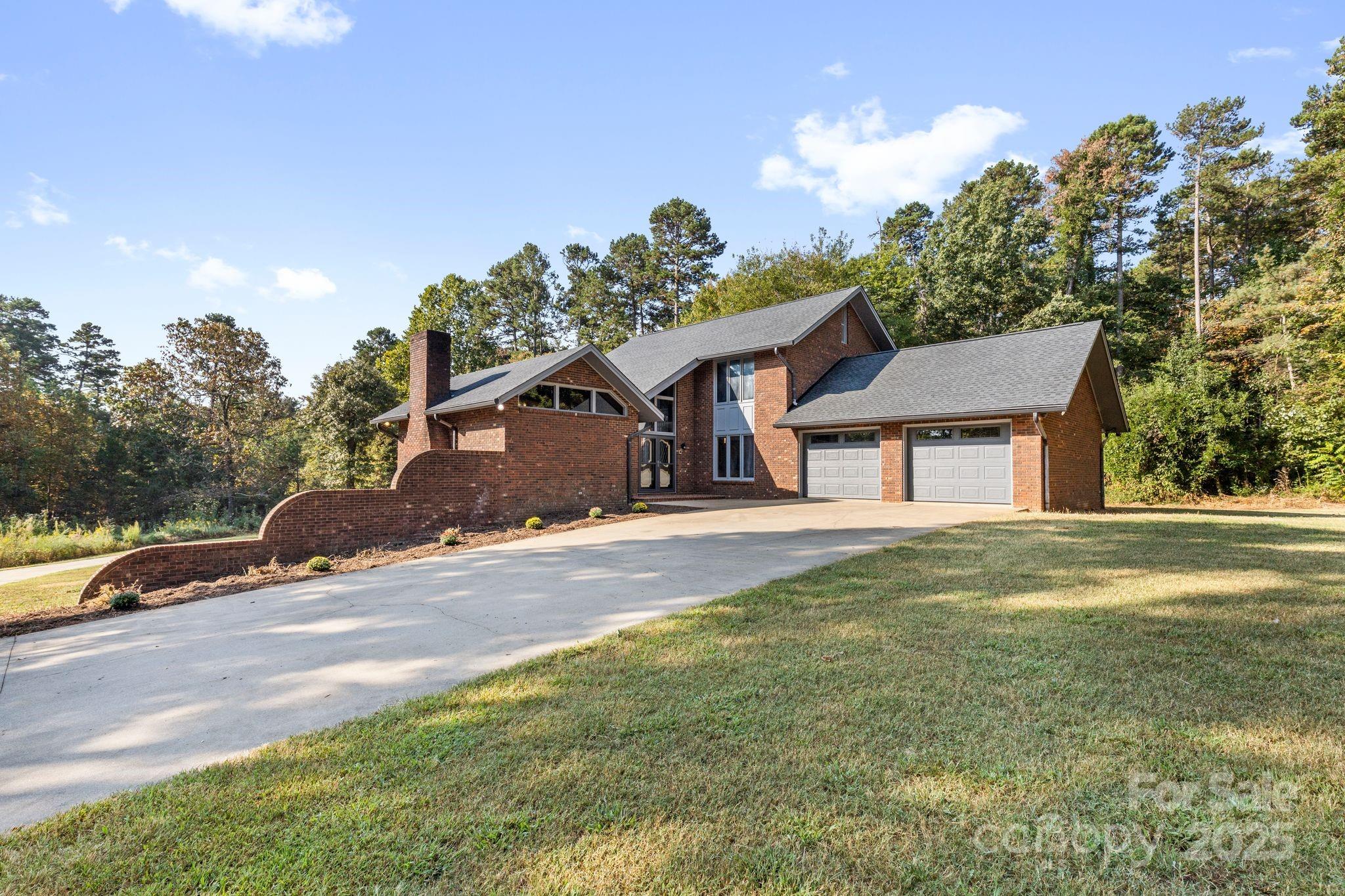 1653 Dudley Shoals Road Granite Falls, NC 28630 - Photo 1 of 48 a front view of a house with a yard and garage