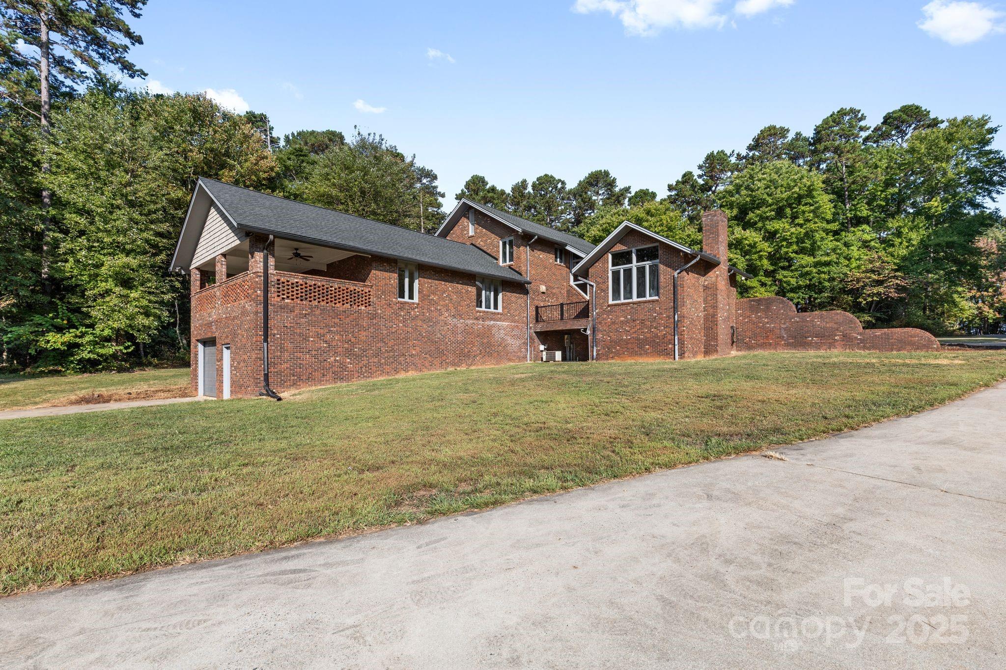 1653 Dudley Shoals Road Granite Falls, NC 28630 - Photo 2 of 48 a front view of a house with a yard and garage