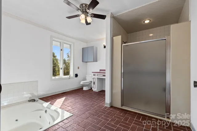 a spacious bathroom with a bathtub and a shower